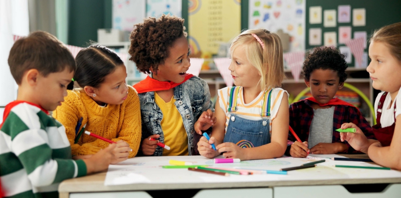 A group of children working together on a table in school