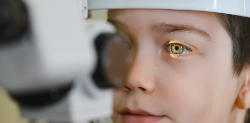A young boy having his eyes examined during an eye exam