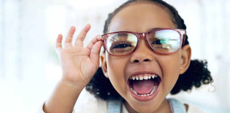 Smiling child wearing prescription glasses