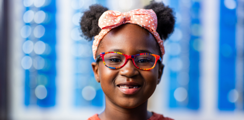 Child wearing colorful eyeglass frames